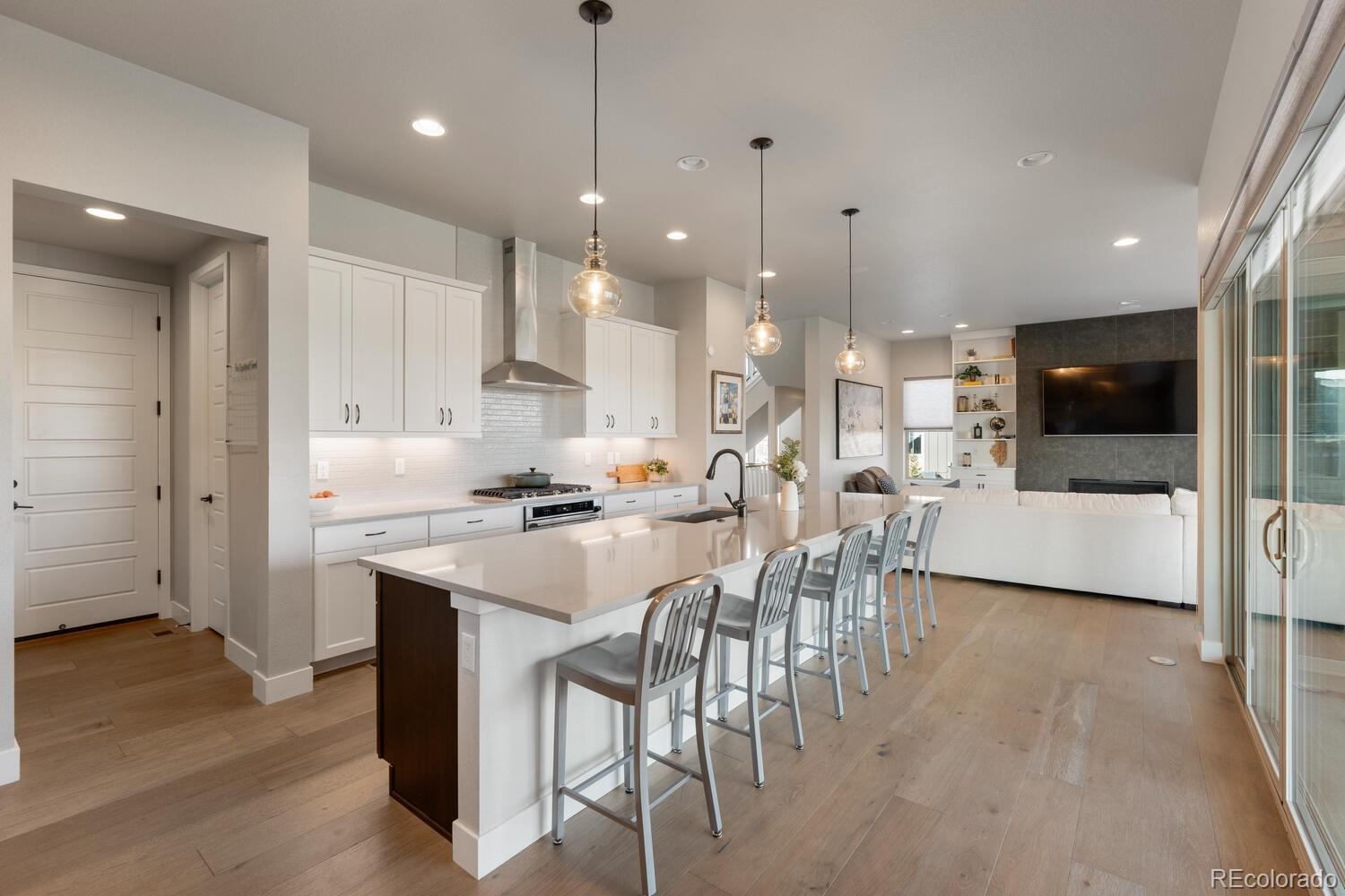 507 Red Thistle Drive Highlands Ranch, CO 80126 - Photo 9 of 42 a kitchen with stainless steel appliances kitchen island granite countertop a sink and a refrigerator