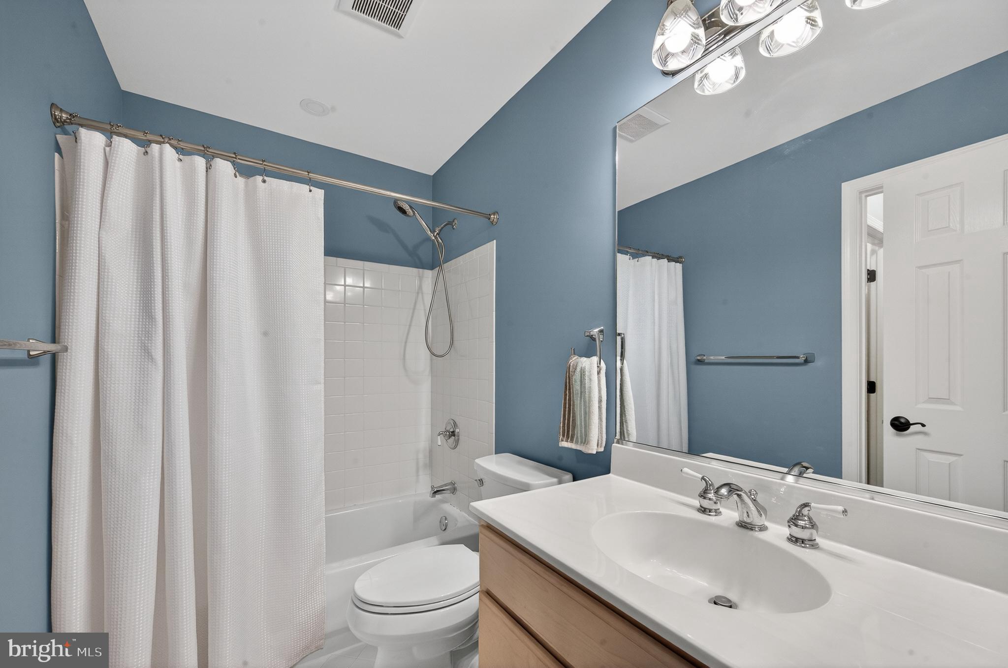 6601 Colchester Road Fairfax Station, VA 22039 - Photo 46 of 78 a bathroom with a sink a toilet and shower curtain