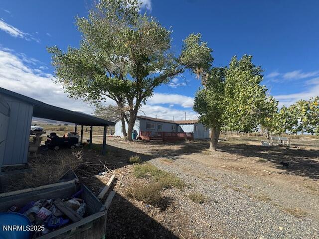 1600 Kyle Hot Springs Road Imlay, NV 89418 - Photo 5 of 45 a backyard of a house with barbeque oven fire pit table and chairs