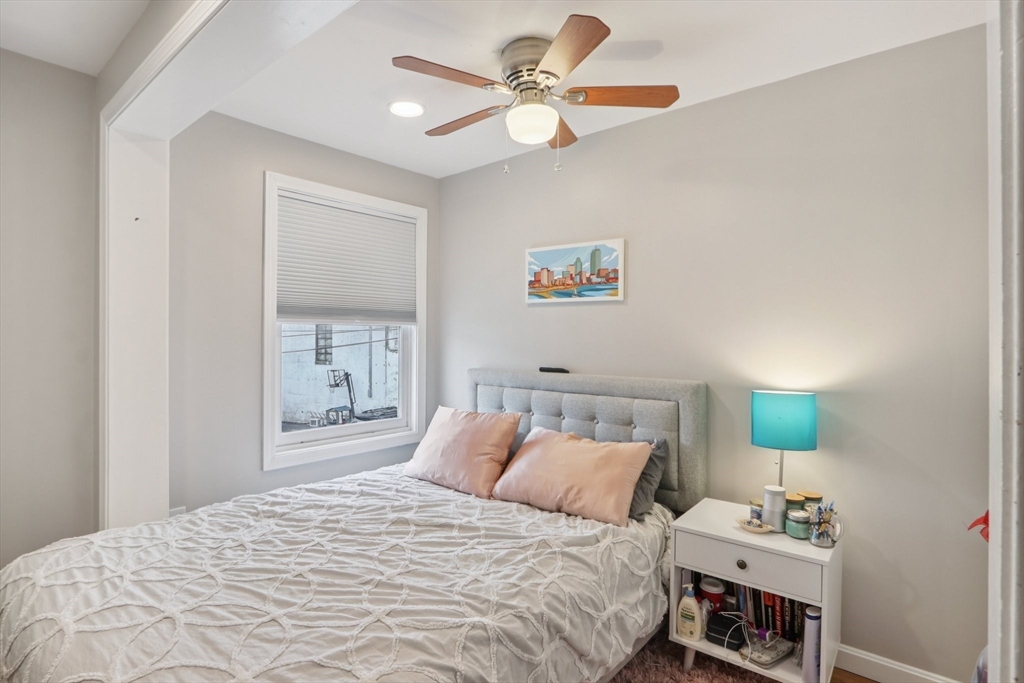 19 Delford Street, Unit 1 Boston, MA 02131 - Photo 13 of 25 a bedroom with a bed and a chandelier