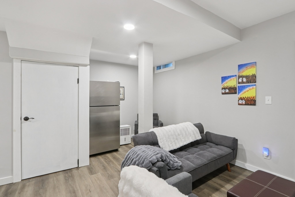 19 Delford Street, Unit 1 Boston, MA 02131 - Photo 18 of 25 a living room with furniture and a refrigerator