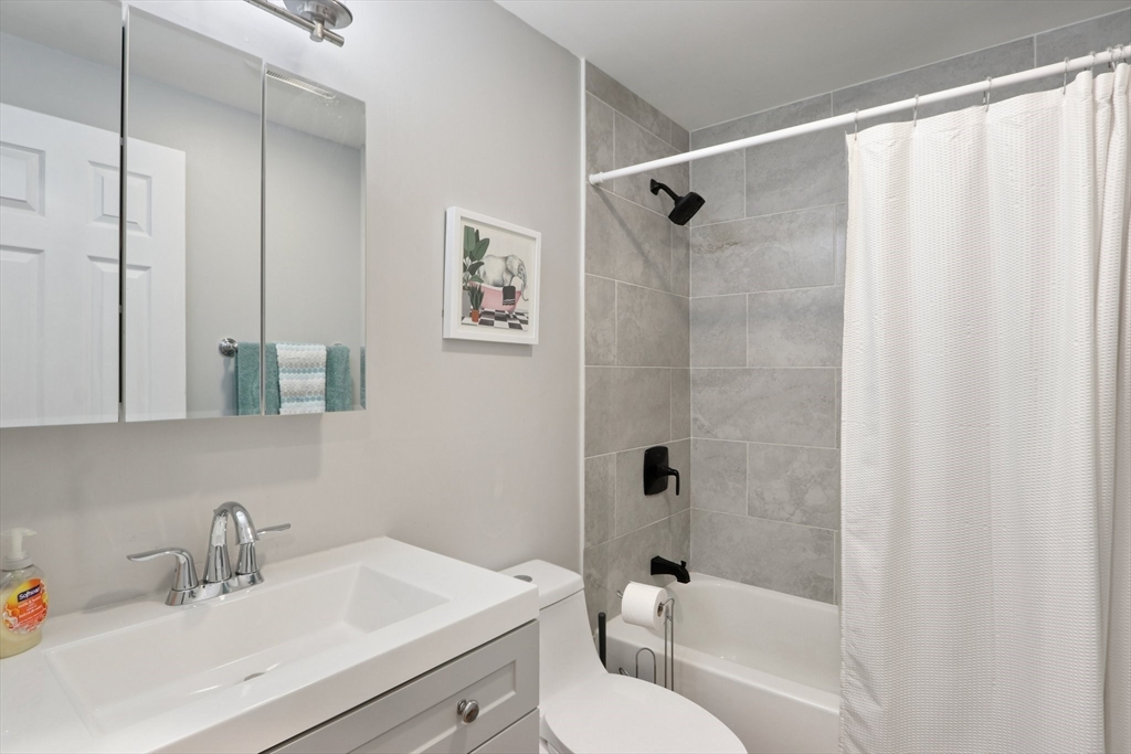 19 Delford Street, Unit 1 Boston, MA 02131 - Photo 20 of 25 a bathroom with a sink toilet and shower