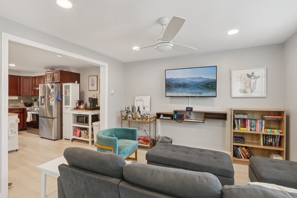 19 Delford Street, Unit 1 Boston, MA 02131 - Photo 4 of 25 a living room with furniture and a kitchen view