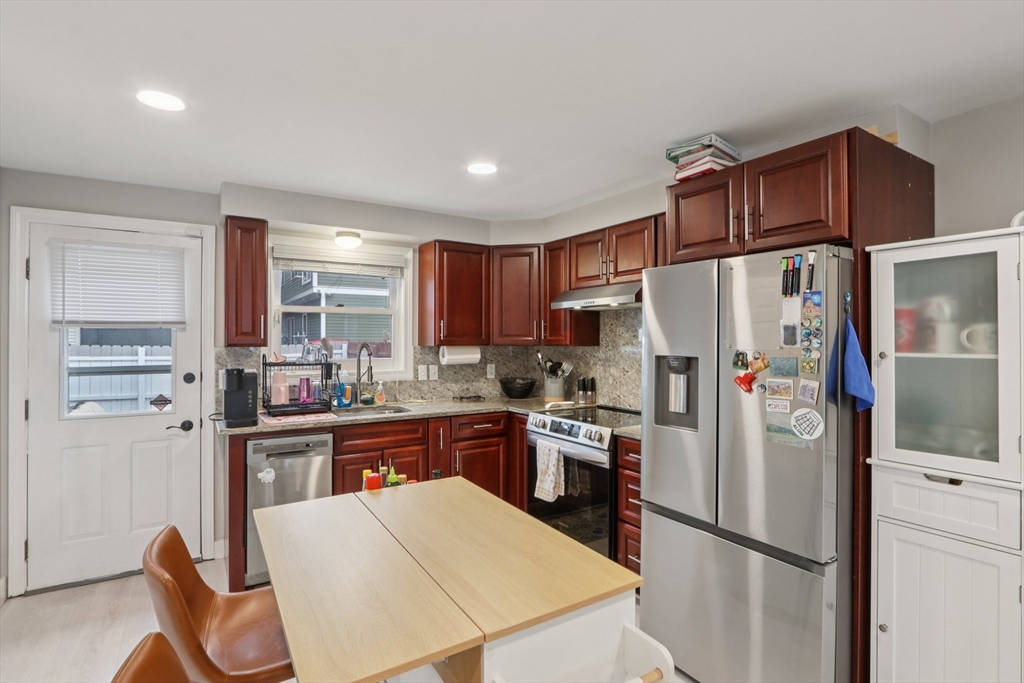 19 Delford Street, Unit 1 Boston, MA 02131 - Photo 6 of 25 a kitchen with stainless steel appliances a refrigerator and a stove top oven