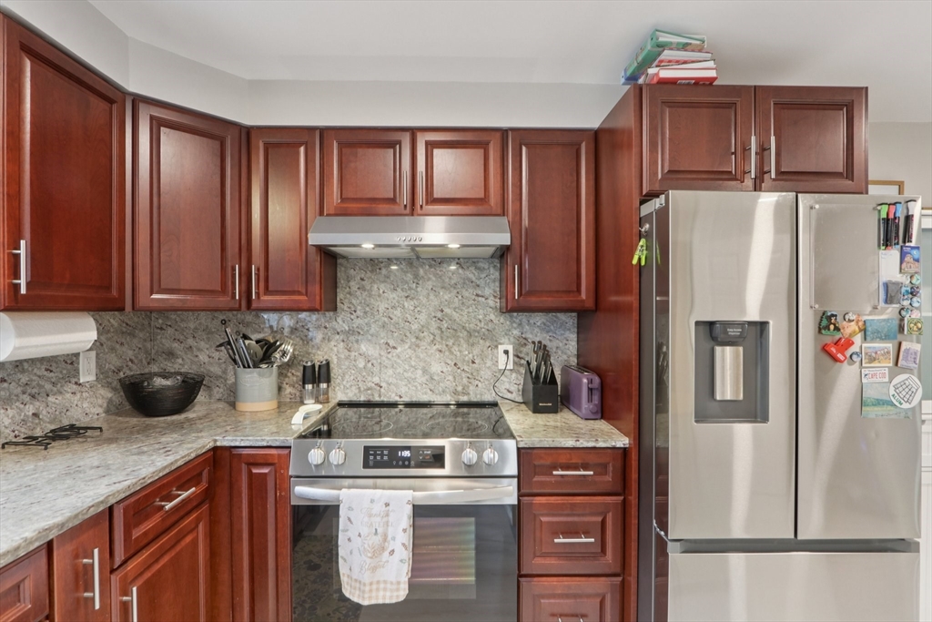 19 Delford Street, Unit 1 Boston, MA 02131 - Photo 7 of 25 a kitchen with stainless steel appliances granite countertop a refrigerator stove and sink