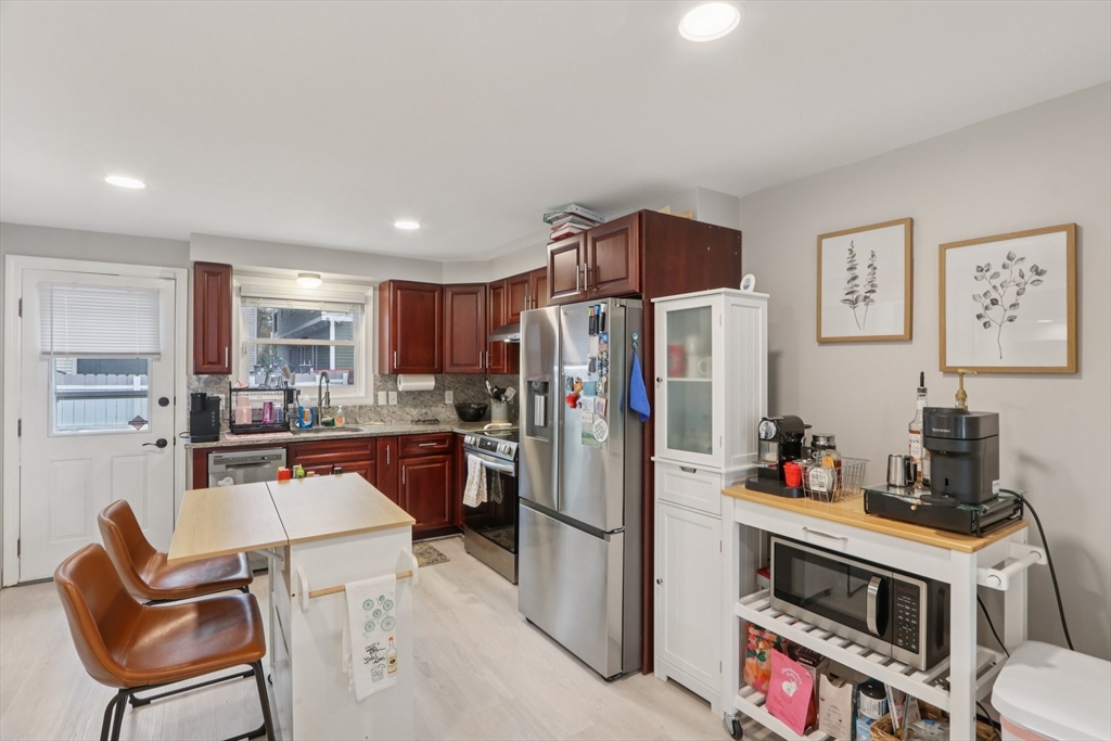 19 Delford Street, Unit 1 Boston, MA 02131 - Photo 8 of 25 a kitchen with stainless steel appliances granite countertop a refrigerator and a stove top oven
