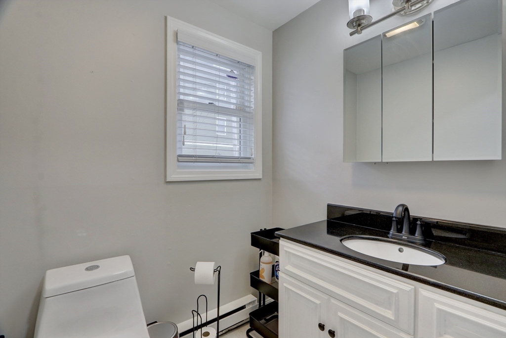 19 Delford Street, Unit 1 Boston, MA 02131 - Photo 9 of 25 a view of a bathroom with a sink a toilet and a window