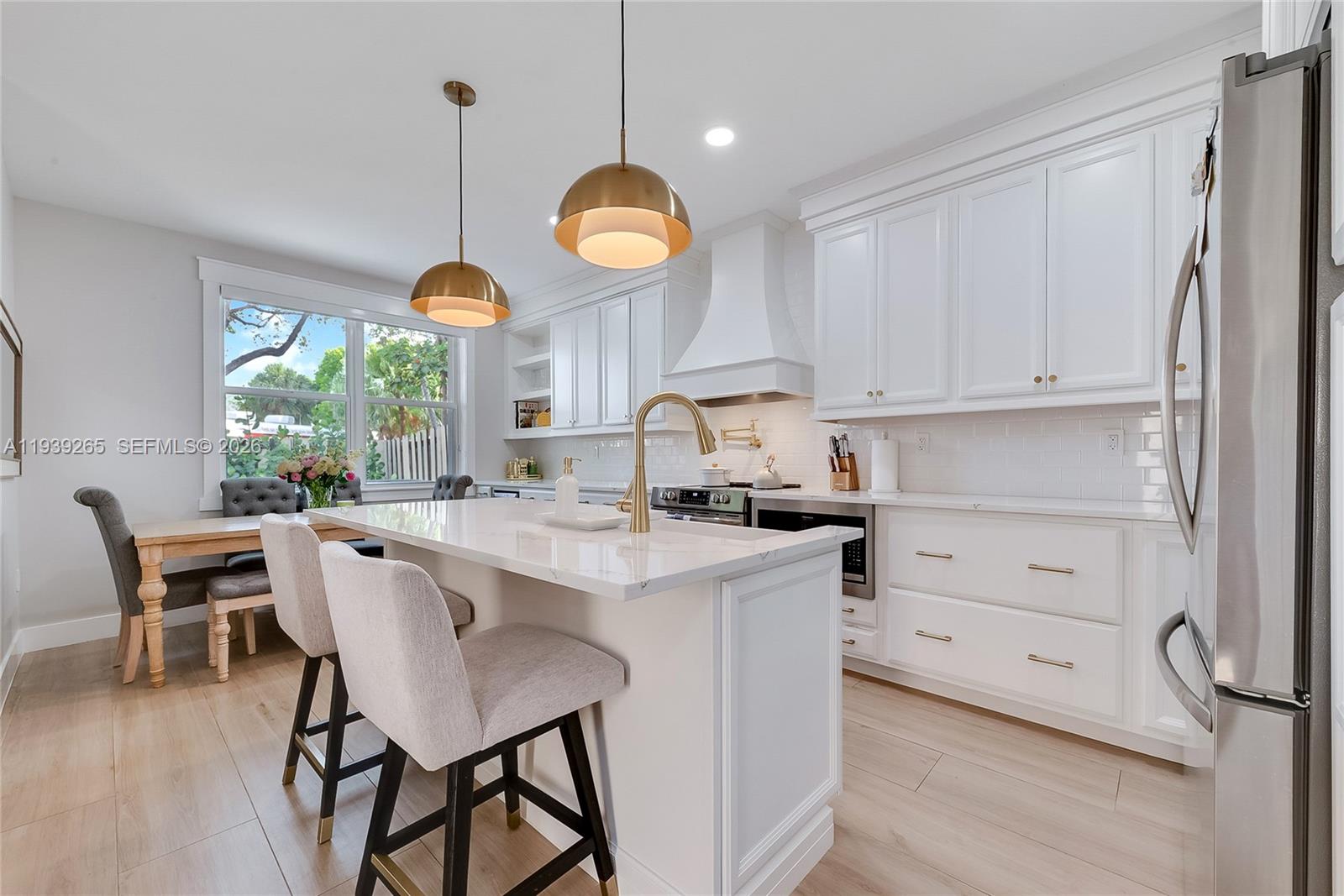 12480 Southwest 125th Terrace Miami, FL 33186 - Photo 1 of 19 a kitchen with a table chairs a window and cabinets
