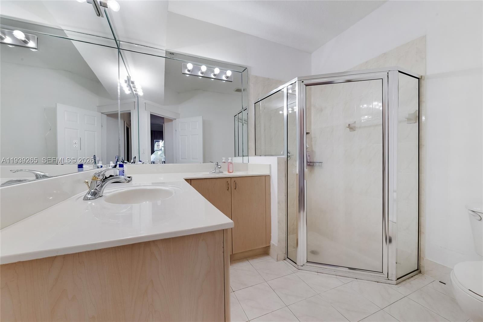 12480 Southwest 125th Terrace Miami, FL 33186 - Photo 11 of 19 a spacious bathroom with a shower a sink and a mirror