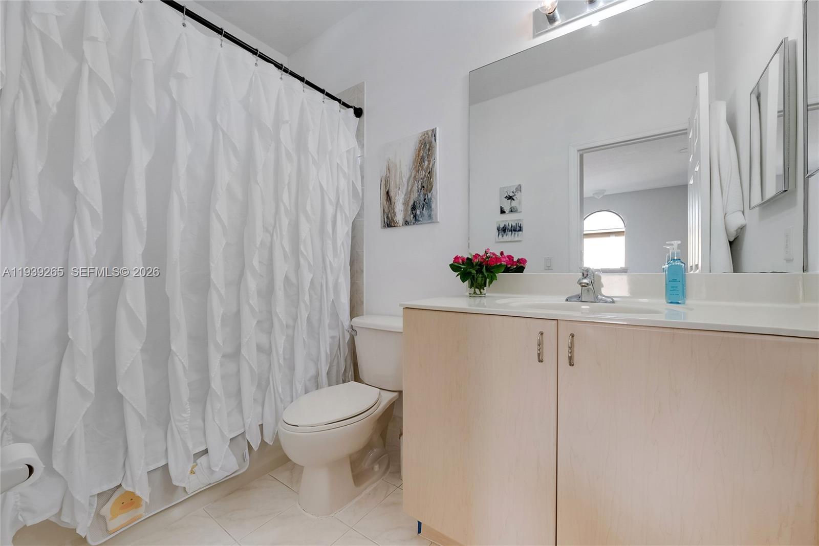 12480 Southwest 125th Terrace Miami, FL 33186 - Photo 15 of 19 a bathroom with a sink a toilet and a mirror