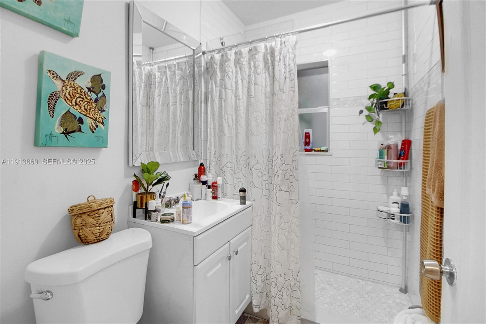 3462 Southwest 27th Street Miami, FL 33133 - Photo 12 of 17 a bathroom with a sink mirror and toilet
