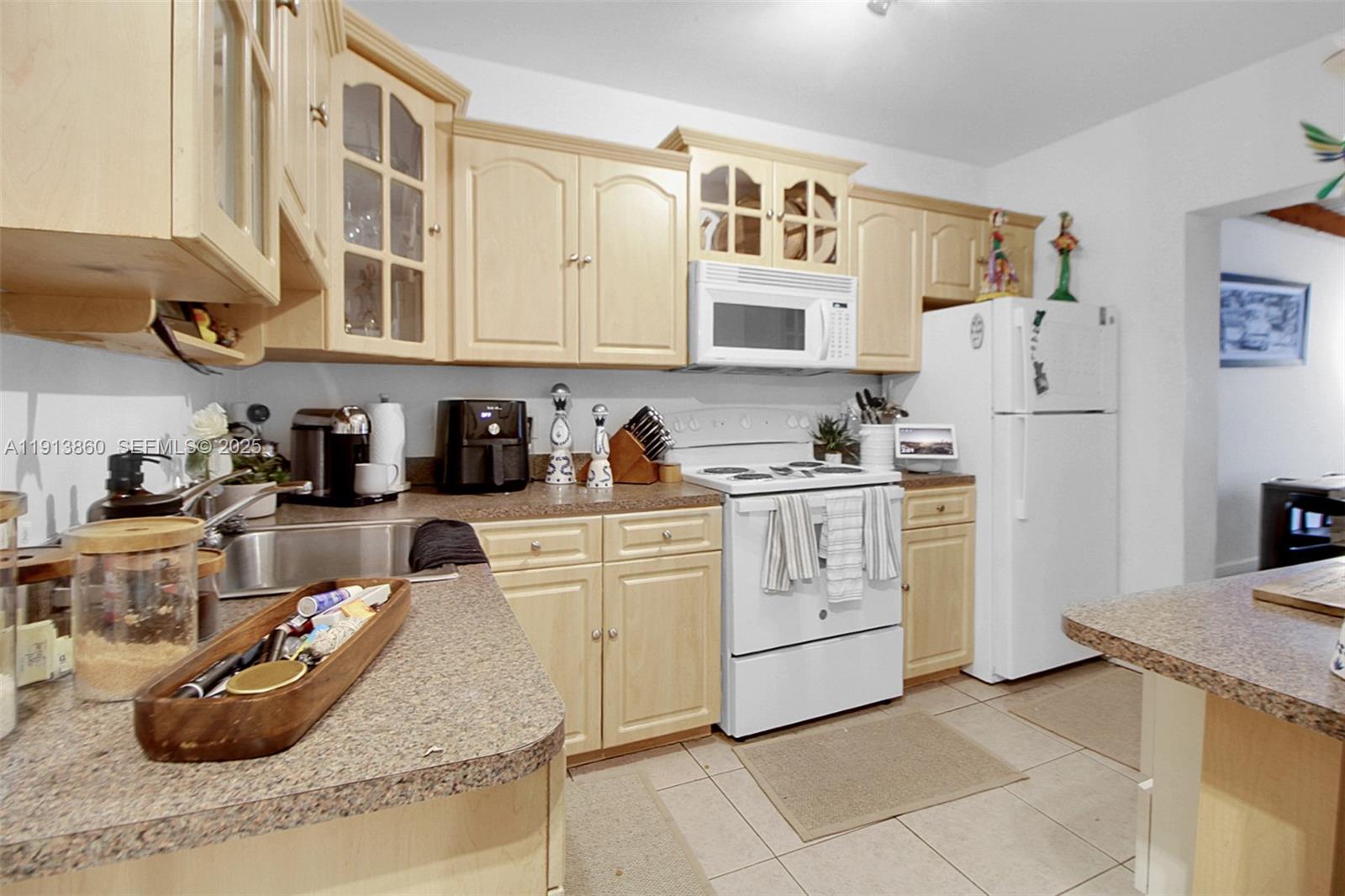 3462 Southwest 27th Street Miami, FL 33133 - Photo 14 of 17 a kitchen with white cabinets and appliances