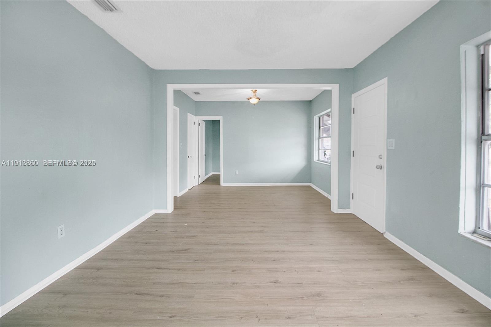 3462 Southwest 27th Street Miami, FL 33133 - Photo 6 of 17 wooden floor in a room with a window