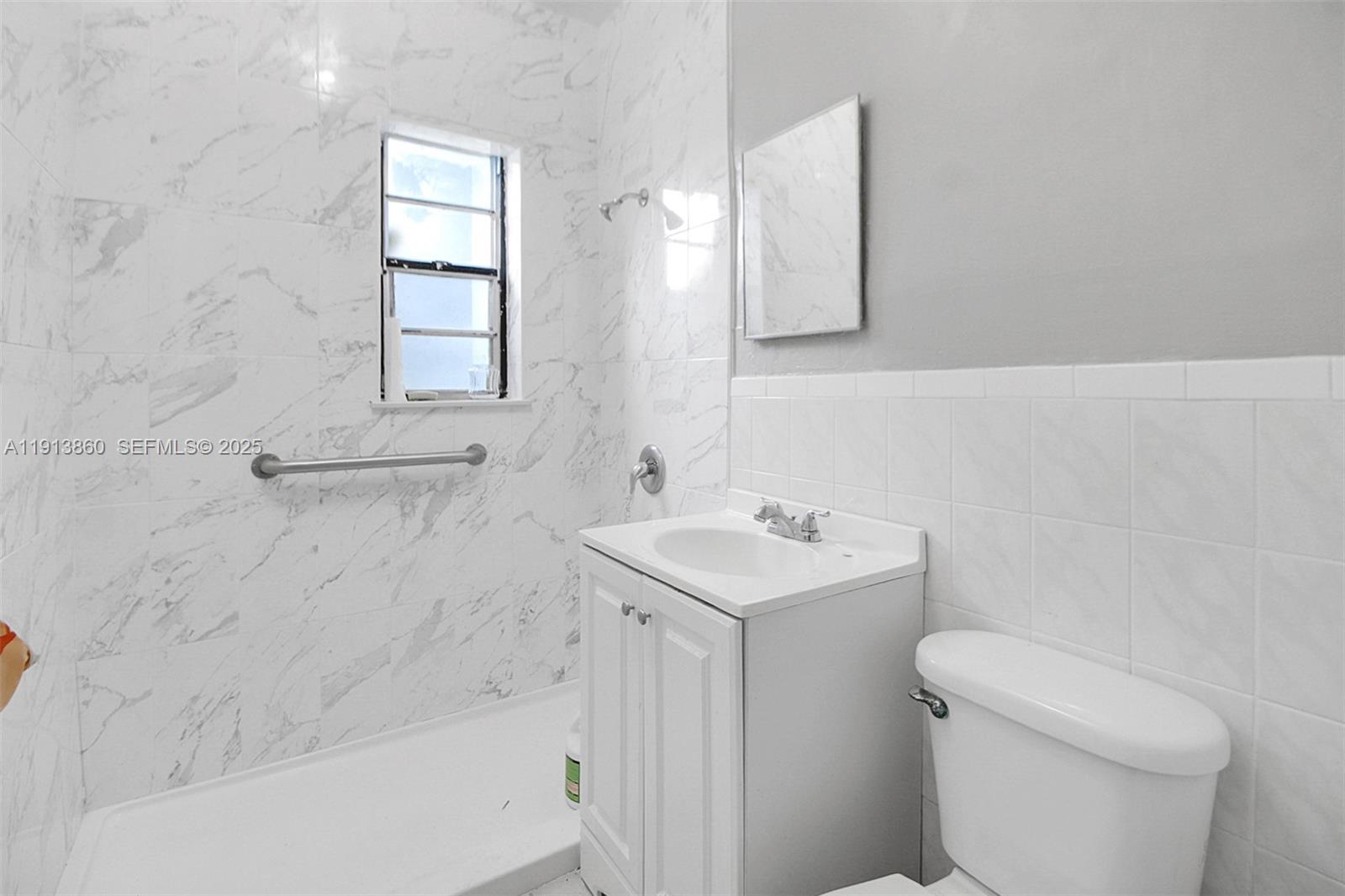 3462 Southwest 27th Street Miami, FL 33133 - Photo 7 of 17 a bathroom with a sink a toilet and vanity