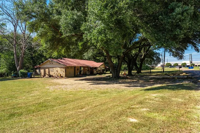 a view of a swimming pool and trees in the background