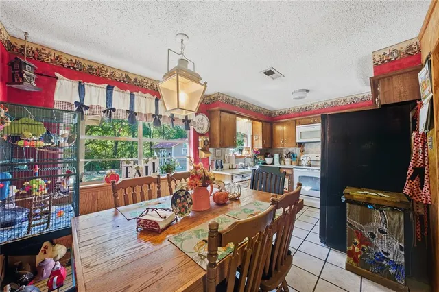 a view of a dining room with furniture a chandelier and wooden floor