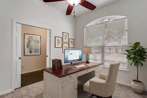 a view of a workspace with furniture and a potted plant