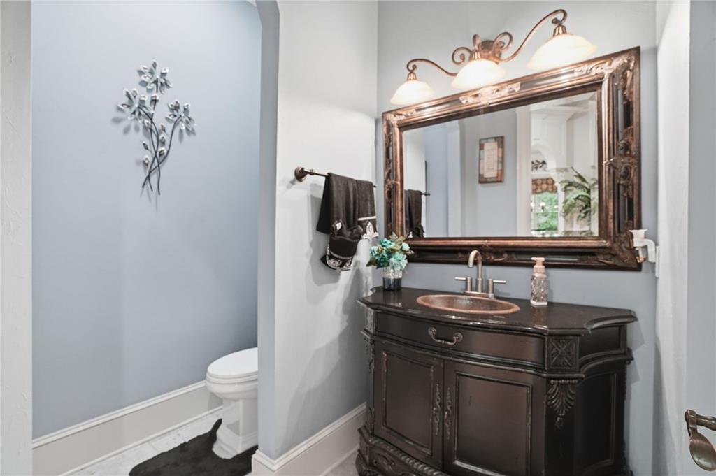 8340 Colonial Place Duluth, GA 30097 - Photo 21 of 74 a bathroom with a toilet sink and mirror