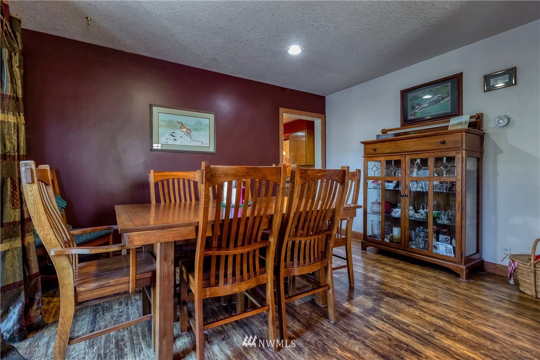 142 Barger Road Prescott, WA 99348 - Photo 8 of 40 a view of a dining room with furniture and wooden floor
