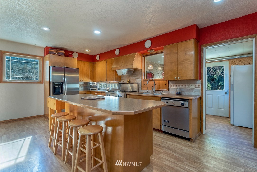 142 Barger Road Prescott, WA 99348 - Photo 10 of 40 a kitchen with stainless steel appliances granite countertop a sink and a refrigerator