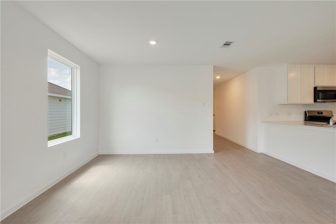 5433 Bear Run Bryan, TX 77807 - Photo 11 of 23 a view of empty room with kitchen and window