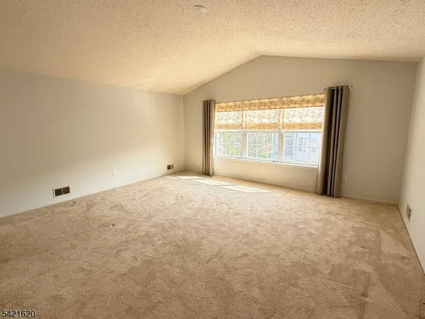 an empty room with a empty space and windows