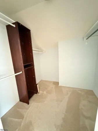 a bathroom with a granite countertop sink toilet a mirror and shower