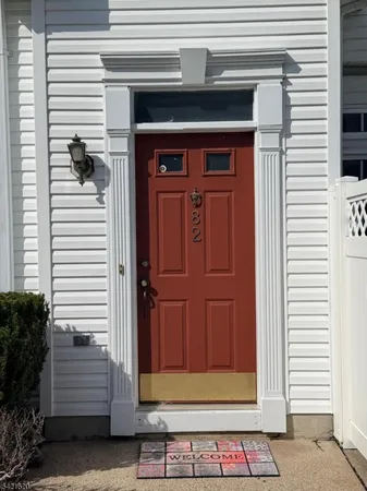 an empty room with windows and fireplace