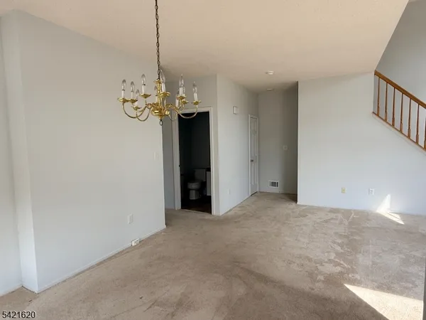a bathroom with a granite countertop sink a toilet and a mirror