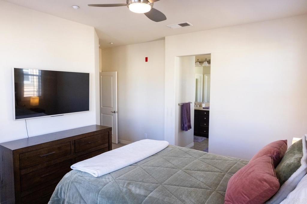 2332 Sentinel Lane San Marcos, CA 92078 - Photo 12 of 24 a bedroom with a bed and a flat screen tv