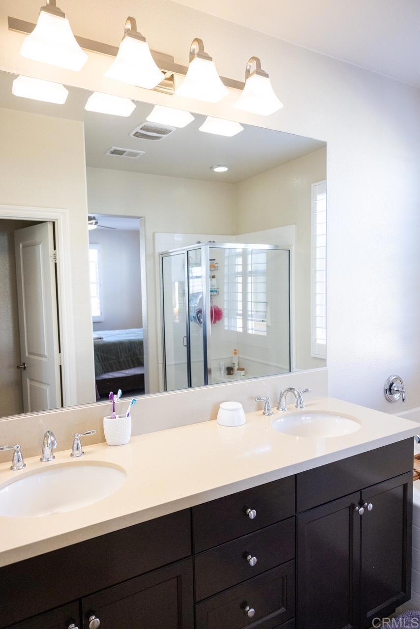 2332 Sentinel Lane San Marcos, CA 92078 - Photo 14 of 24 a bathroom with a double vanity sink and a mirror