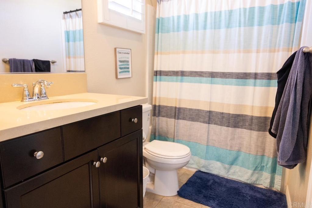 2332 Sentinel Lane San Marcos, CA 92078 - Photo 16 of 24 a bathroom with a sink a toilet a mirror and shower