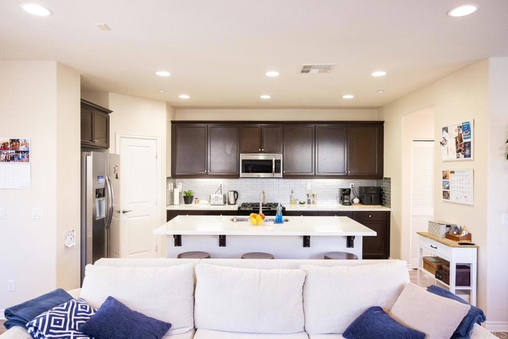 2332 Sentinel Lane San Marcos, CA 92078 - Photo 7 of 24 a kitchen with stainless steel appliances kitchen island granite countertop a sink and cabinets