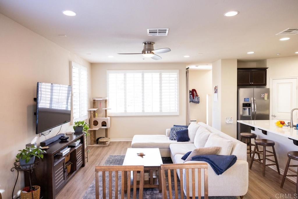2332 Sentinel Lane San Marcos, CA 92078 - Photo 8 of 24 a living room with furniture a flat screen tv and a large window