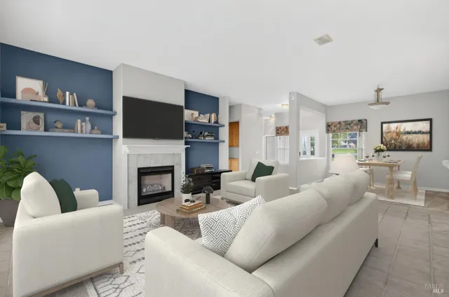 a living room with furniture a fireplace and a flat screen tv