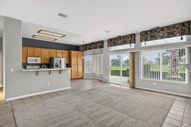 a view of a kitchen with a sink and a large window