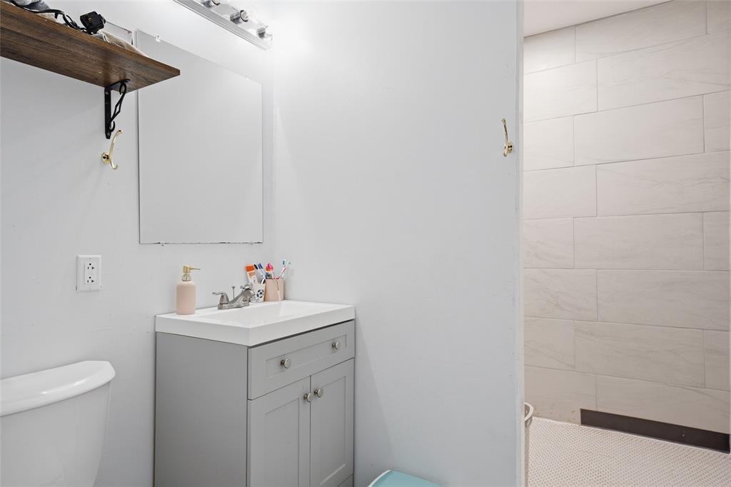 151 Kasberg Road Leroy, TX 76691 - Photo 21 of 40 a bathroom with a sink a toilet and vanity