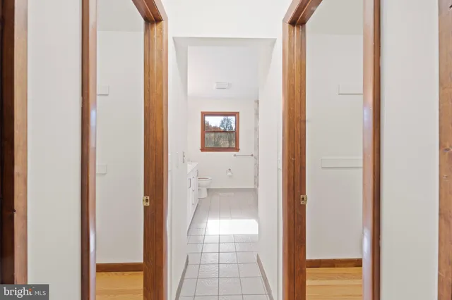 a view of a hallway with wooden floor