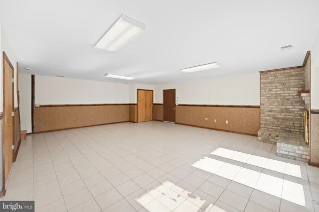 a view of wooden floor and windows in a room