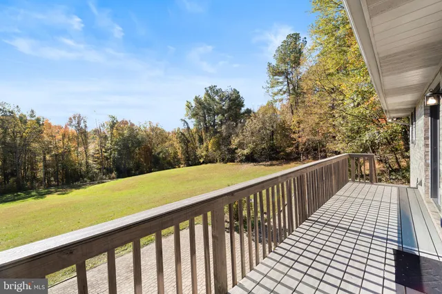 a view of a balcony with wooden fence