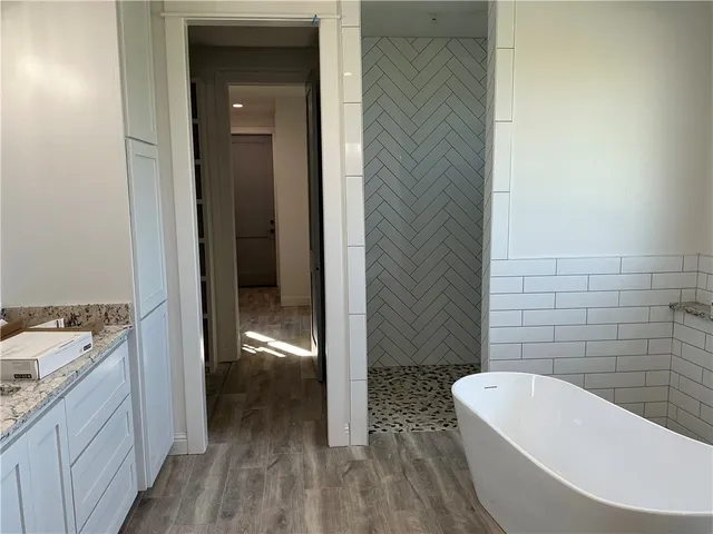 a view of entryway and hall with wooden floor