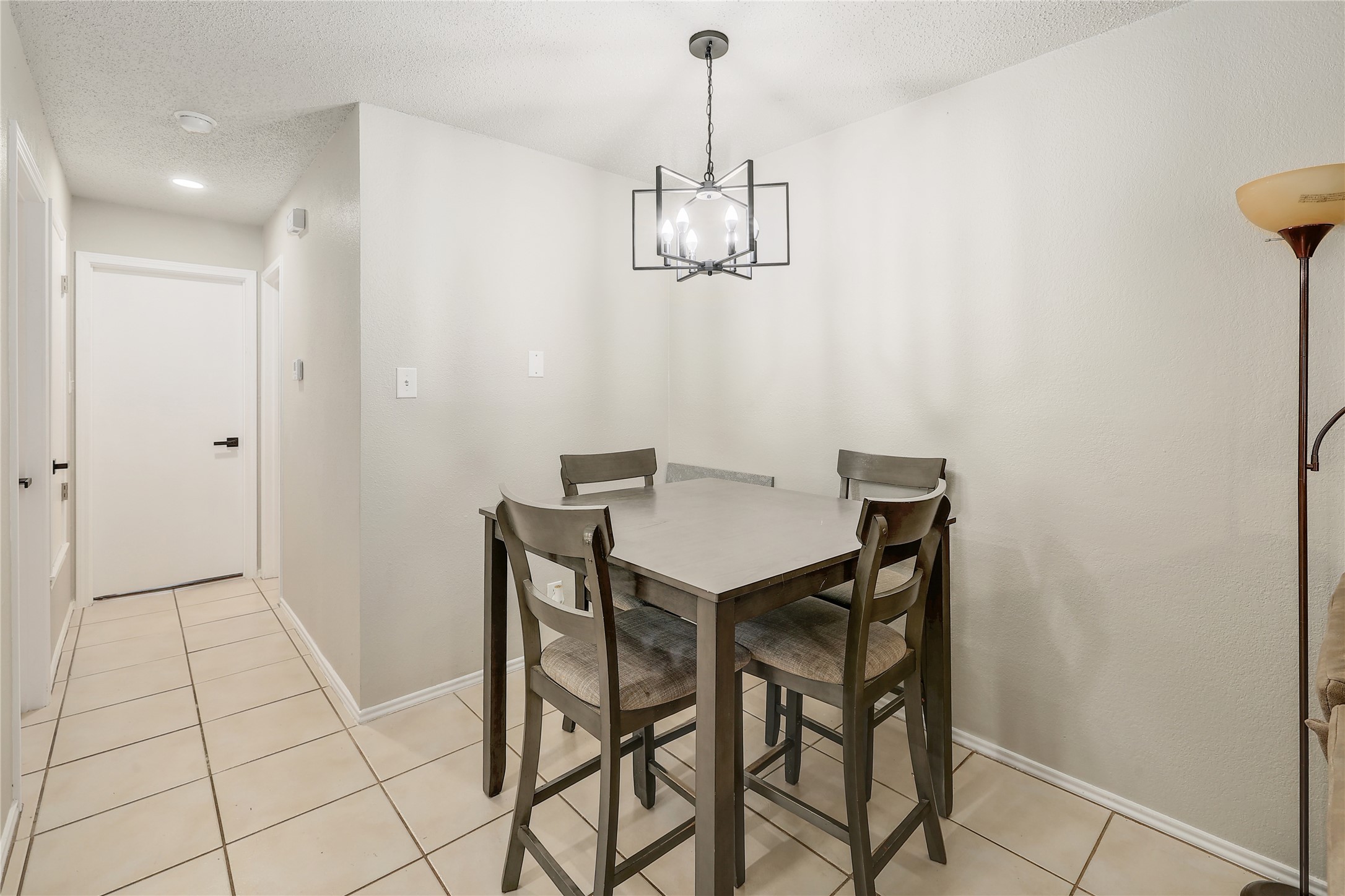 9906 Parliament House Road Austin, TX 78729 - Photo 32 of 33 An intimate dining area anchors the floor plan with neutral walls and durable tile flooring.
