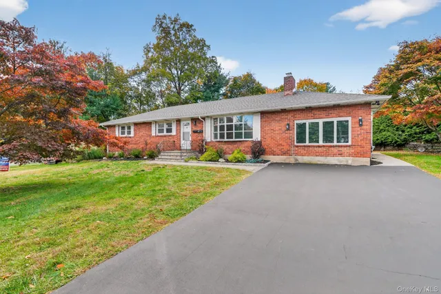 a front view of house with yard and green space