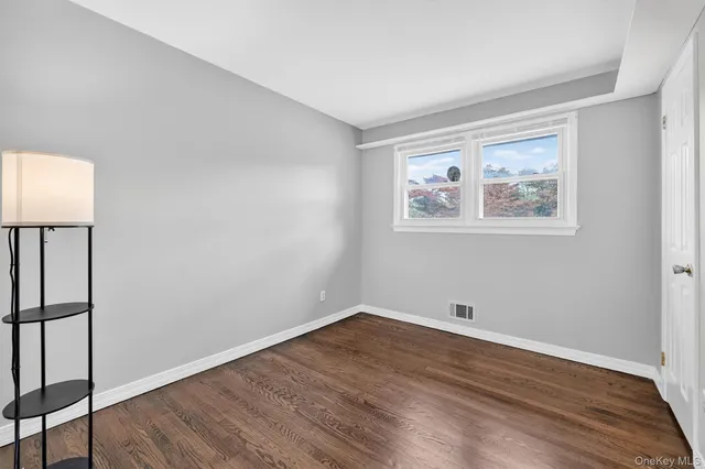 a view of room with wooden floor and window