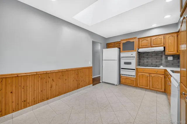 a view of an empty room with a kitchen
