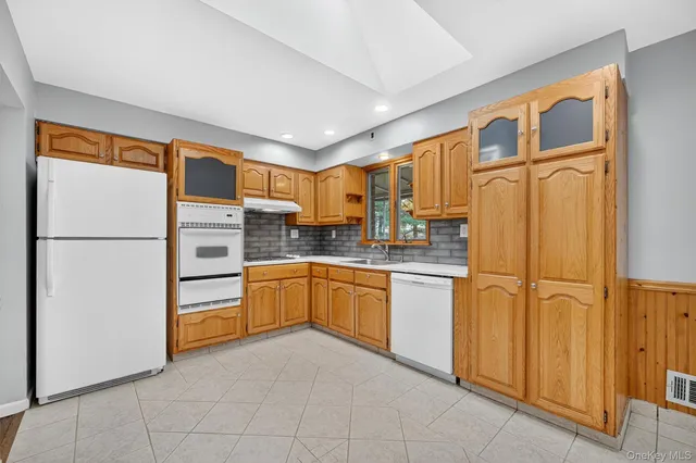 a kitchen with stainless steel appliances granite countertop a refrigerator sink and cabinets