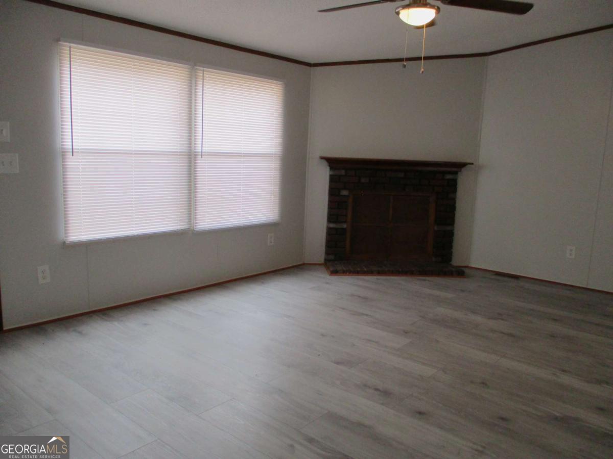 606 Cline Road Northwest Resaca, GA 30735 - Photo 12 of 49 an empty room with a fireplace and windows