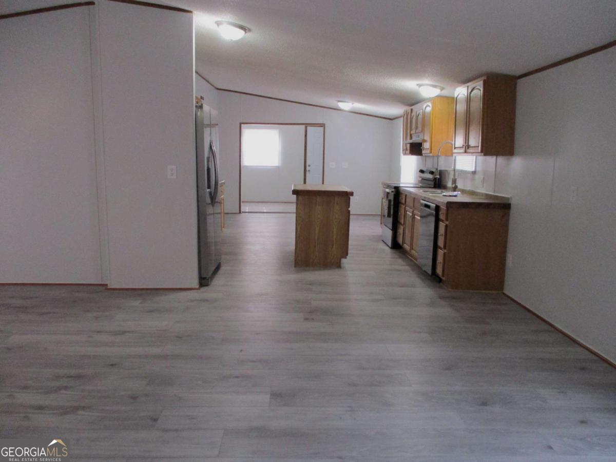 606 Cline Road Northwest Resaca, GA 30735 - Photo 17 of 49 a kitchen with stainless steel appliances granite countertop a refrigerator a sink a stove and oven