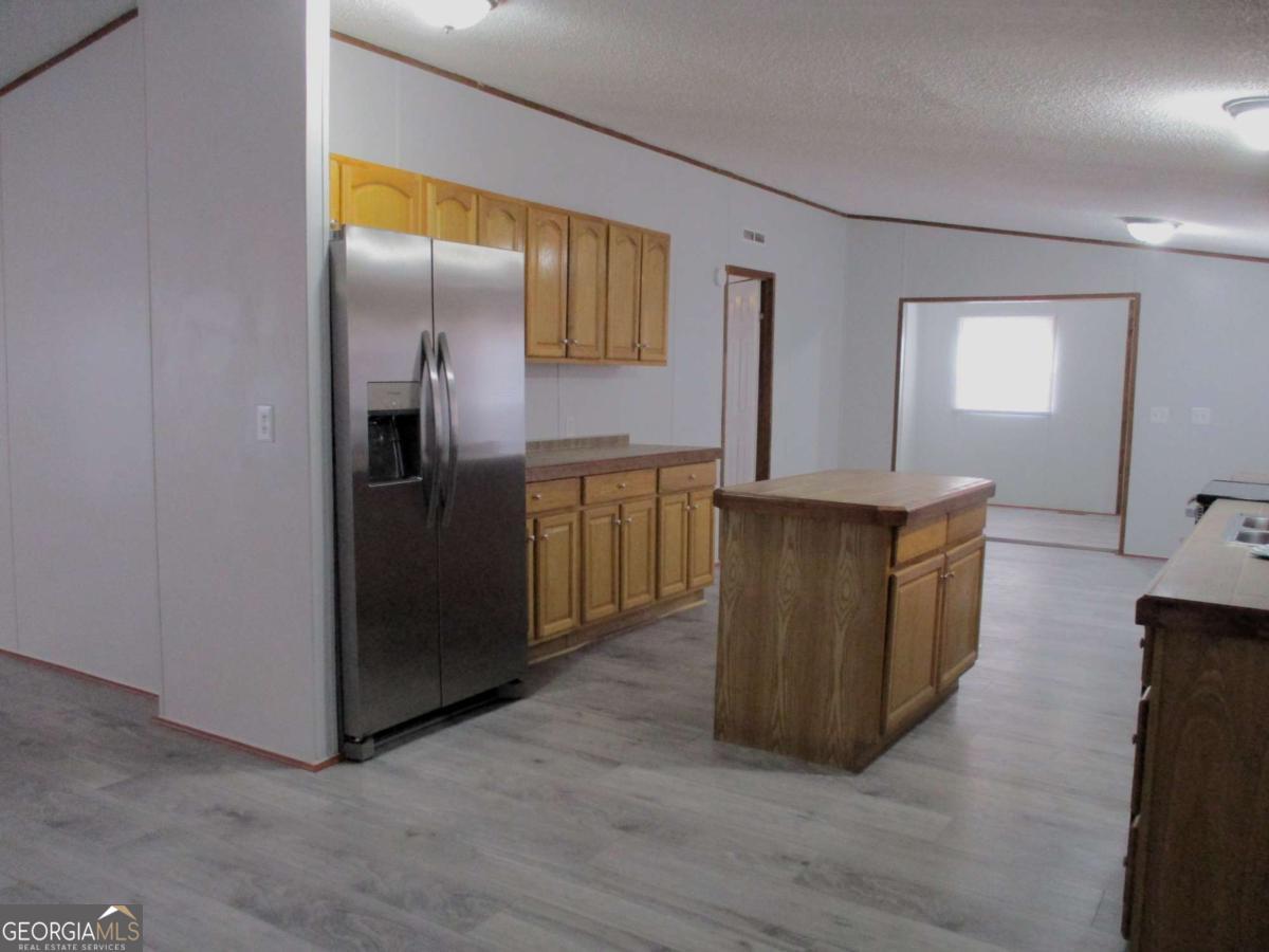 606 Cline Road Northwest Resaca, GA 30735 - Photo 19 of 49 a kitchen with stainless steel appliances granite countertop a refrigerator and a sink