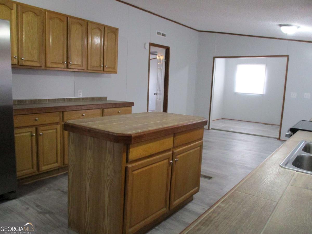 606 Cline Road Northwest Resaca, GA 30735 - Photo 20 of 49 a kitchen with stainless steel appliances granite countertop a sink stove and cabinets